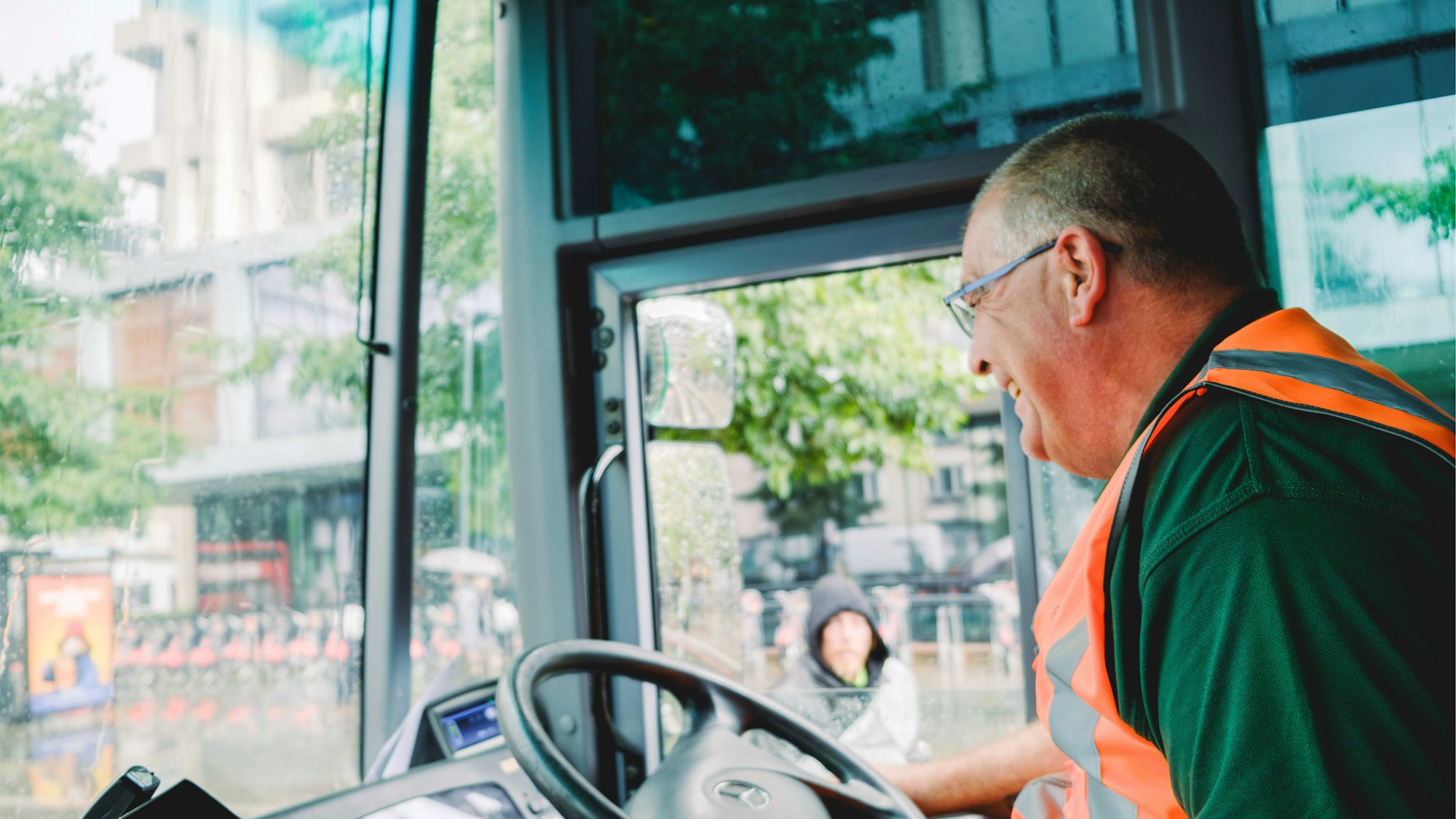 Recorra RCV driver sitting in his cab smiling out the window.