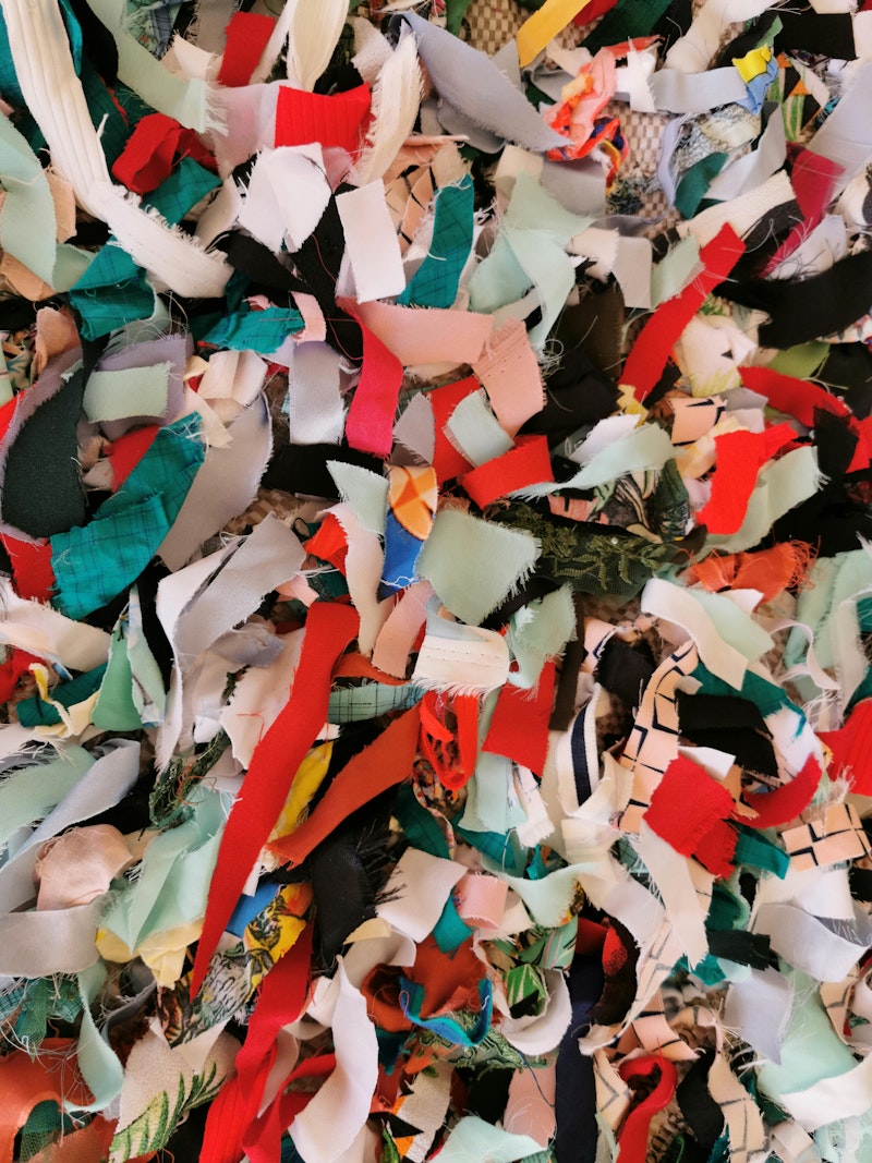 pile of shredded branded clothing