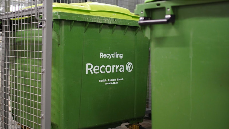 1100l wheeled green dry mixed recycling bin, inside of a store room.