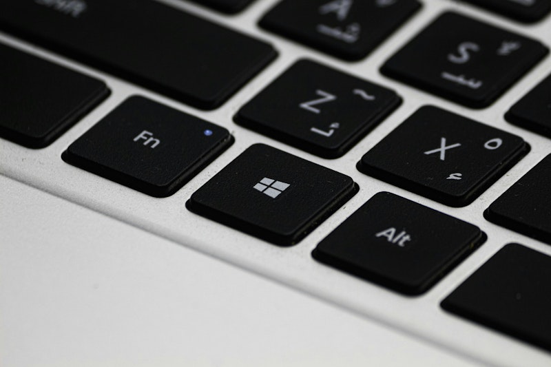 Zoomed in shot of a keyboard, the camera is focus on the windows button with a gradual blur going outwards.