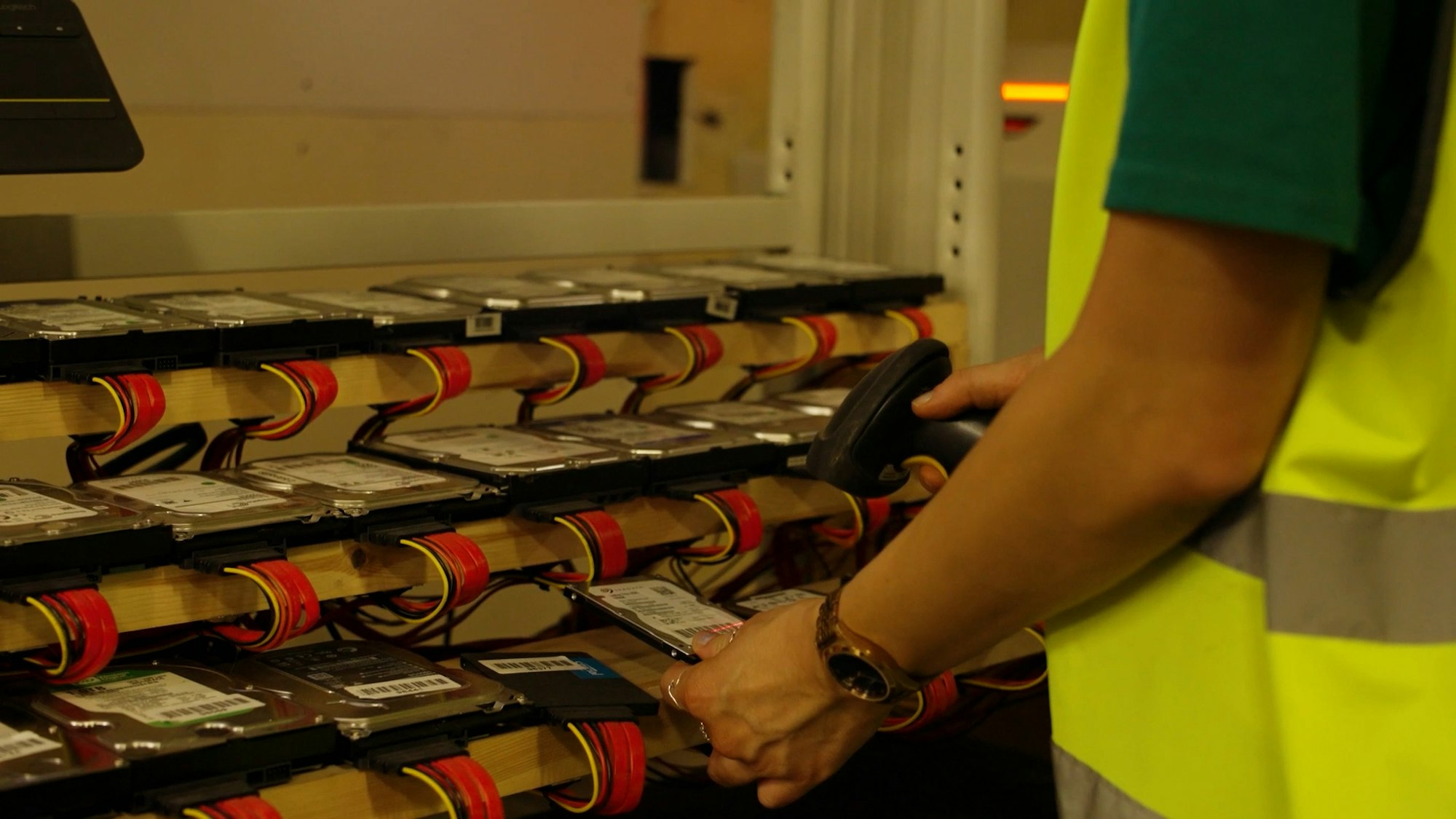 Blancco secure data destruction at Recorra's facility in Purfleet. 3 lines of hard rives are hooked up to the system with a working scanning barcodes for each of the hard drives.
