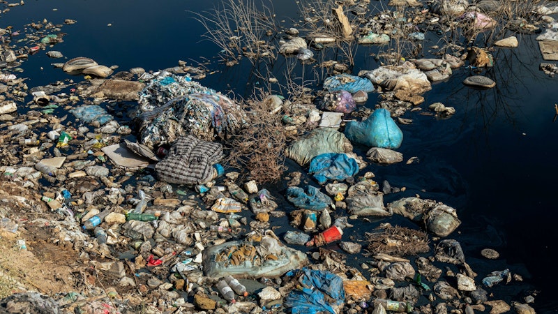 A lake filled with contaminated products, leading to environmental issues in the land.